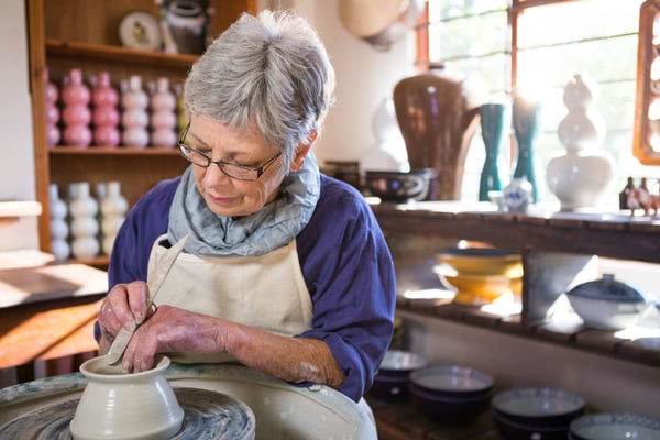 senior working with pottery
